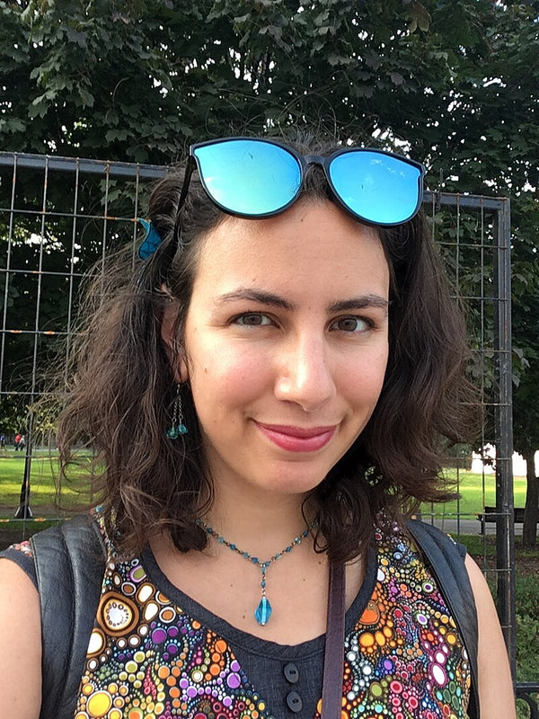 Woman with sunglasses on her head in a park setting
