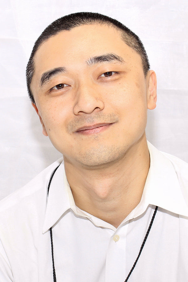 Man wearing a white shirt with a plain background