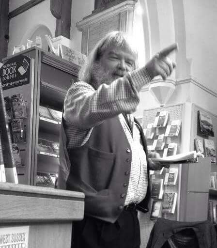 Man pointing at a bookshelf in a bookstore