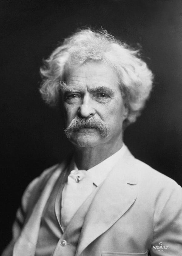 Black and white portrait of a man with a mustache against a dark background