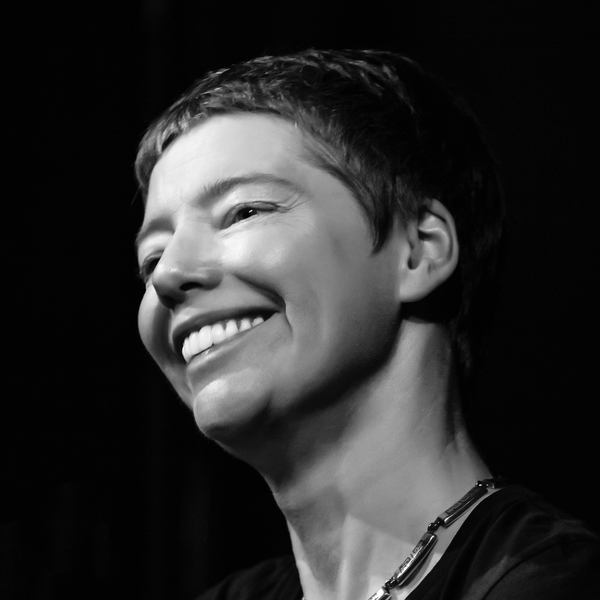 Black and white portrait of a woman with short hair smiling.