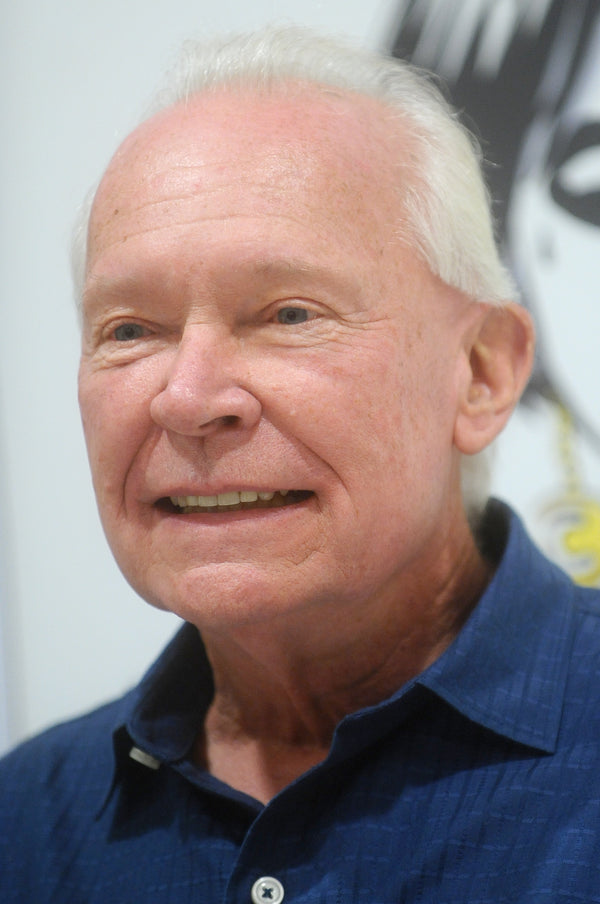 Man wearing a blue shirt with a blurred background