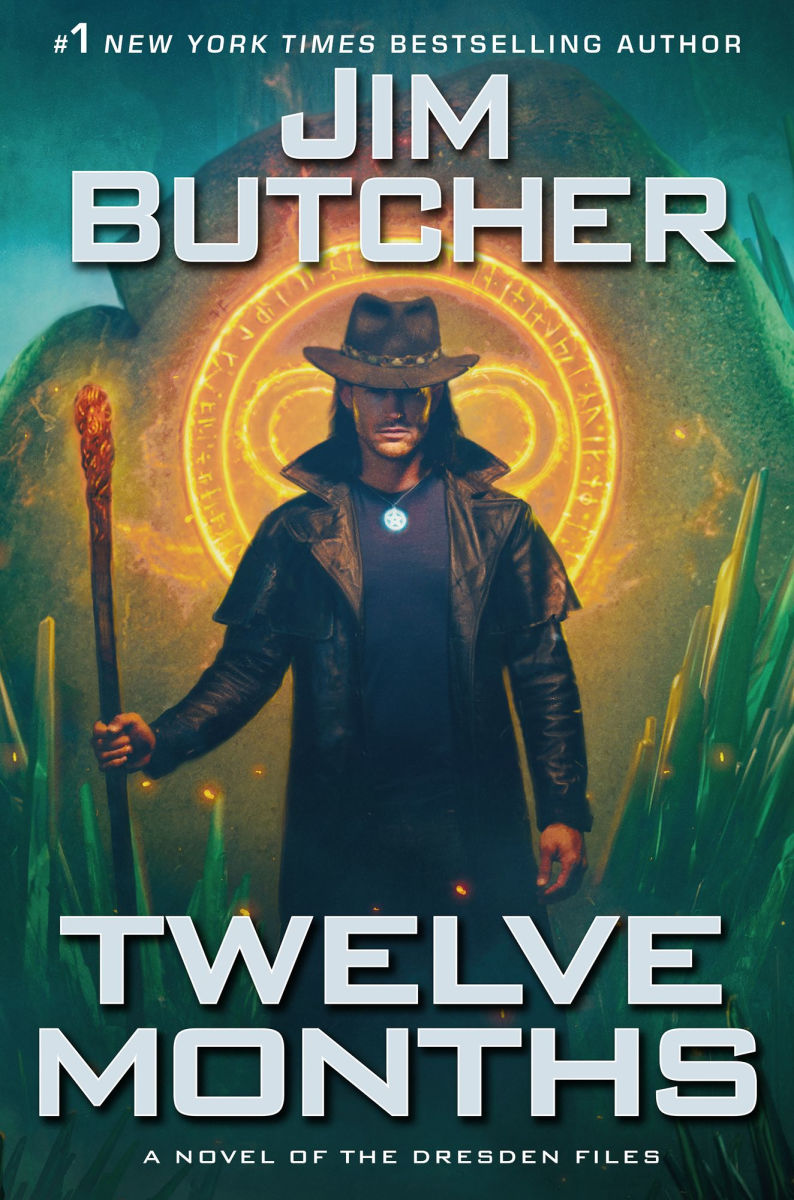Book cover of 'Twelve Months' by Jim Butcher featuring a character holding a staff with a glowing circle in the background.