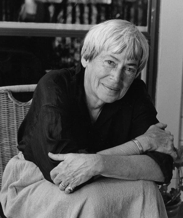 Black and white photo of a person sitting with arms crossed